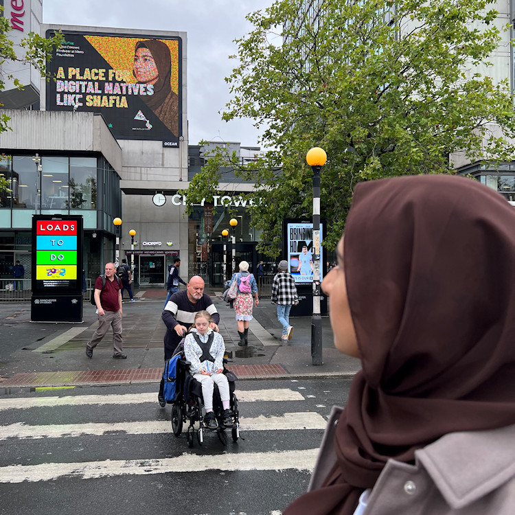 Shafia admiring the work she helped create in her role as part of the Manchester Publicity Association’s ‘A Place for You’ campaign to celebrate diverse role models.