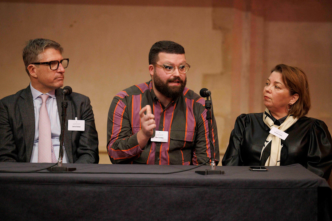 Ben Conway Speaking on a panel (photograph)