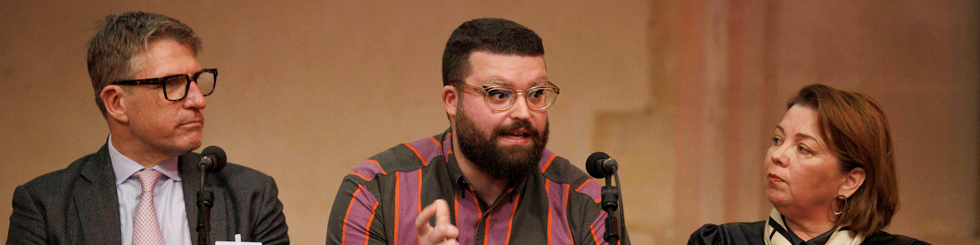 Ben Conway Speaking on a panel (photograph)