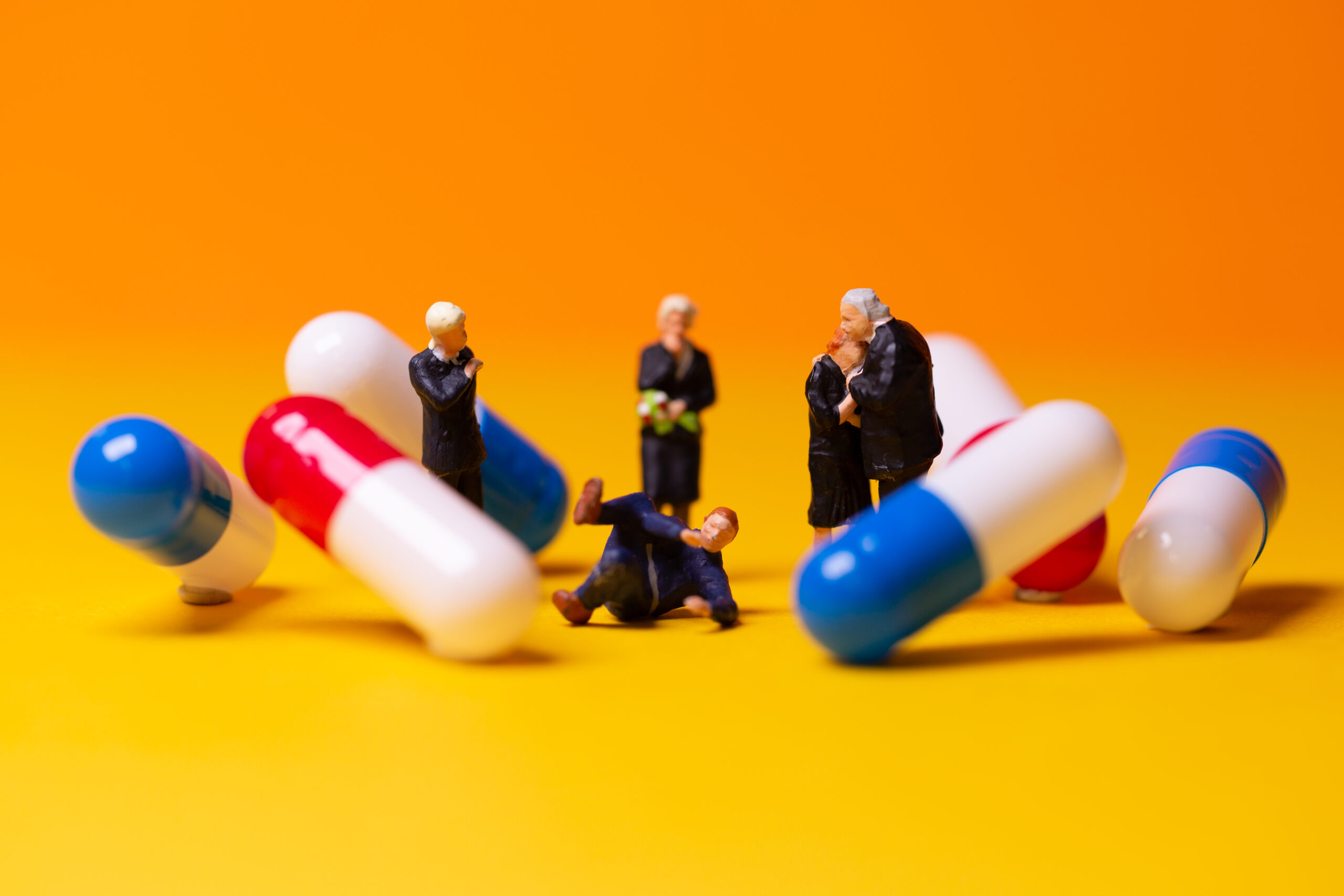 Macrophotograph businessmen surrounded by giant pills