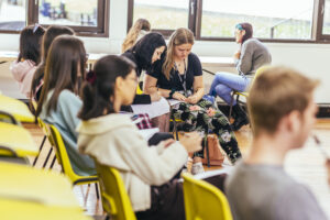 students sitting in yellow chairs at workshop